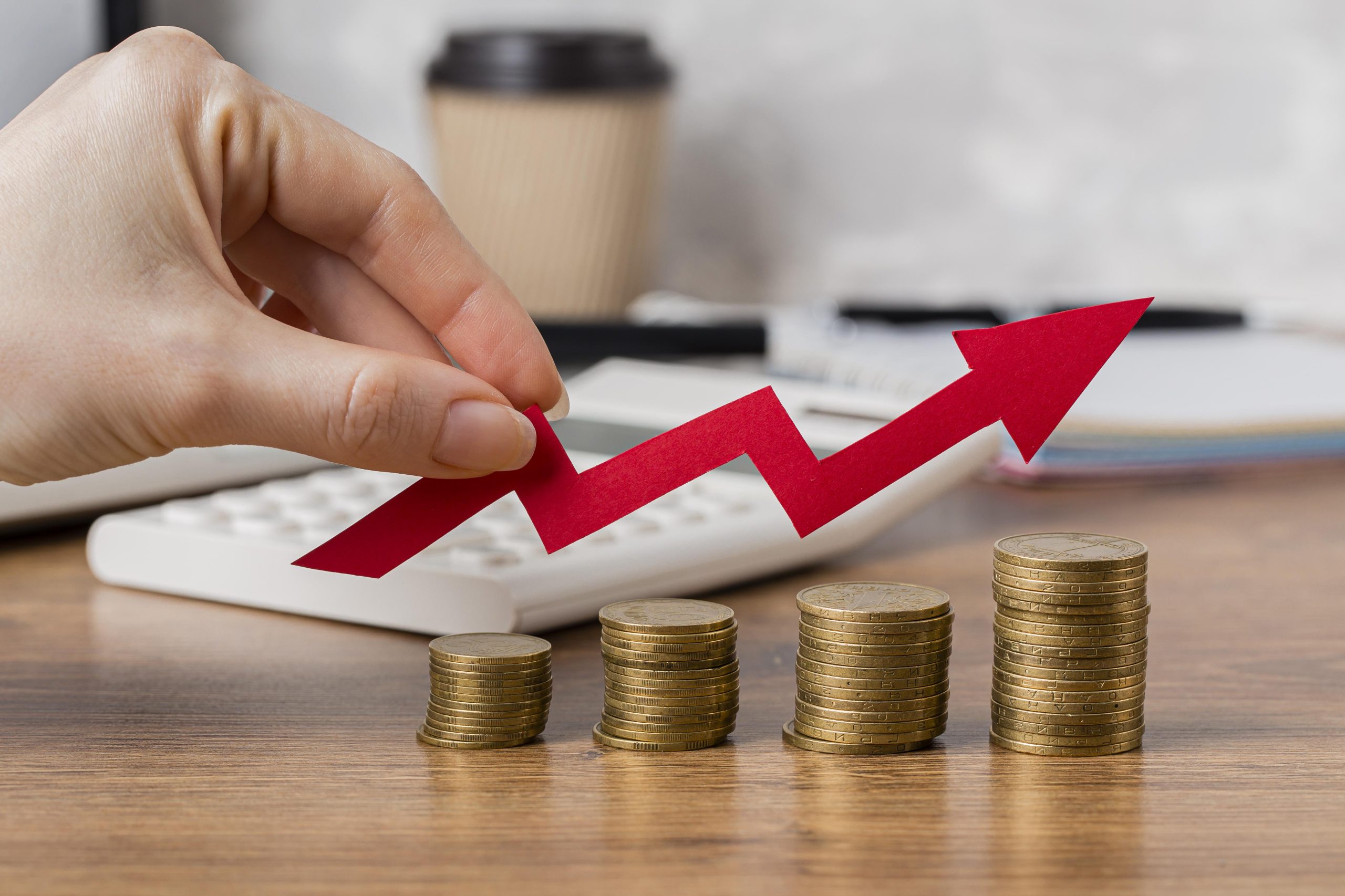 hand holding growth arrow with coins hand holding growth arrow with coins