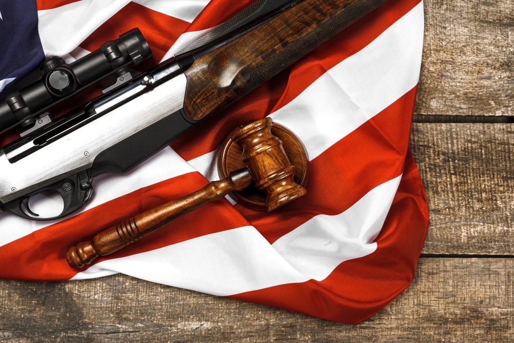 wooden-judge-gavel-hunting-rifle-usa-flag-wooden-background